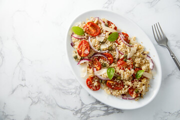 Warm couscous salad with tomatoes and red onion