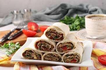 Lavash roll with eggplant, tomato and garlic on gray background, Homemade vegetarian appetizer