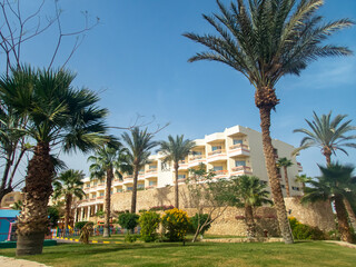 Fototapeta na wymiar Beautiful view of the Egyptian hotel with palm trees, flowers and a swimming pool