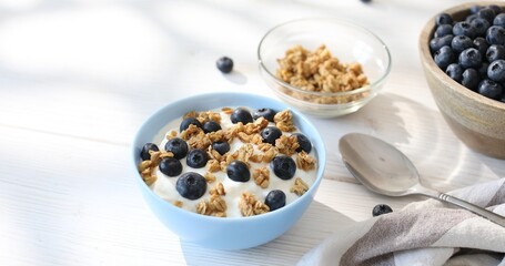 Granola with yogurt and blueberries. Breakfast with muesli and berries. Healthly food. Close-up.