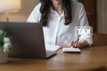 Businesswoman using laptop for online income tax return form. Symbolic of financial research,...