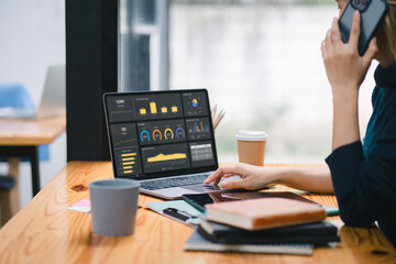 The data analyst woman working on a business analytics dashboard, utilizing charts and metrics to...
