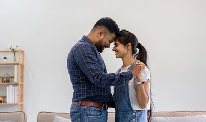 couple living together cuddling in the living room happy expression of love.