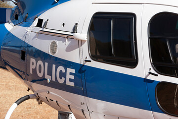 police helicopter parked on the ground, close up on the doors