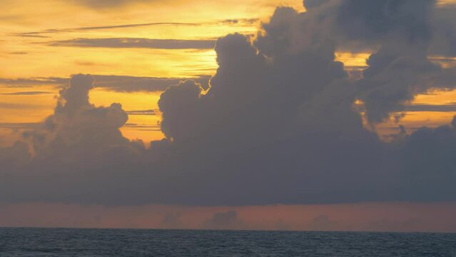 Timelapse. Big bright Yellow sun down behide big cloud . Awesome landscape of sky and silhouette.