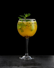 An enticing cocktail blending martini and passion fruit, presented with finesse against a sophisticated black backdrop, highlighting its vibrant allure and refreshing composition