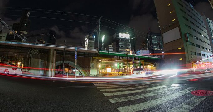 Traffic and subway futuristic light streaks on urban Tokyo streets night 4K timelapse. 