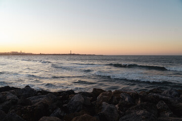 view of El Hank Lighthouse seen from Hassan II Mosque at sunset - Casablanca, Morocco