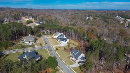 Upper middle-class neighborhood with quiet residential street, large two-story houses on huge...