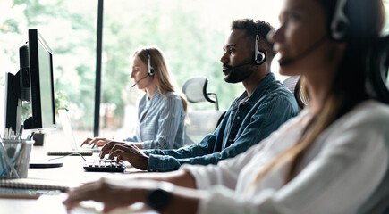 Team of business people working in a call centre on the line. - 644001768