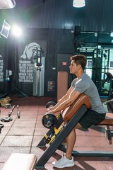 Asian man is fully dedicated to his seated bench press weight lifting exercise, emphasizing his...