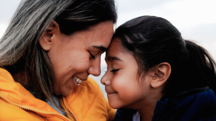 Happy Hispanic mother and child enjoying together outdoor - Family love relationship - Mom and daughter concept
