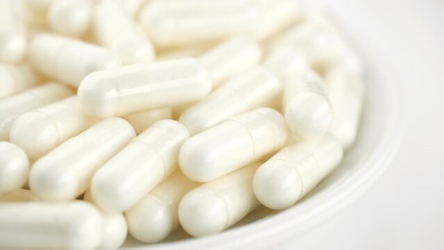 White capsule, Collagen capsule in white plate, rotate