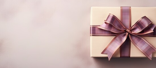 Close up of two checkered gift boxes with a red violet ribbon and bow isolated on a isolated pastel background Copy space