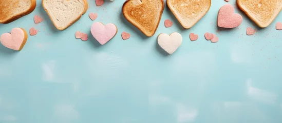 Fotobehang Heart shaped sandwiches and bread make a tasteful arrangement on the table isolated pastel background Copy space © HN Works