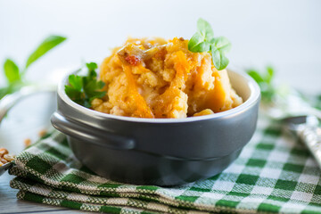 Cooked pea porridge with spices and seasonings in a ceramic bowl .