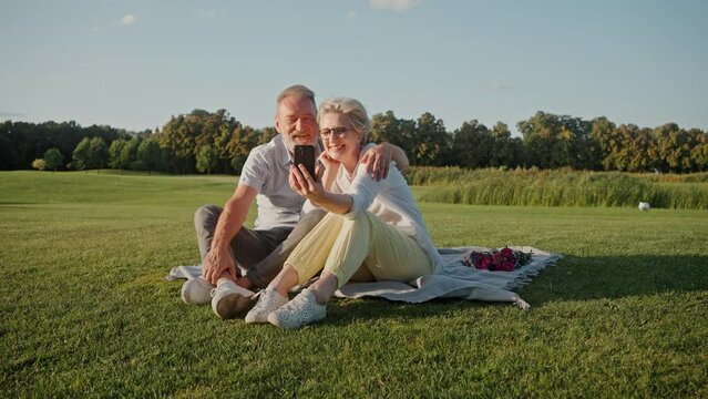 Aged spouses communicating through video call on smartphone