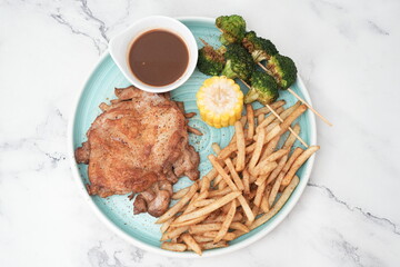 chicken chop with fries, corn and greens