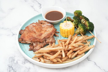 chicken chop with fries, corn and greens