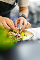 Chef cooking Beef tongue salad with fresh vegetables on restaurant kitchen