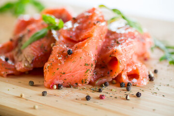 Fresh big pieces of salted red fish with spices and herbs .