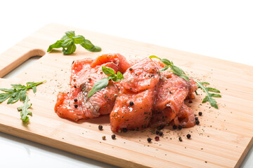 Fresh big pieces of salted red fish with spices and herbs .