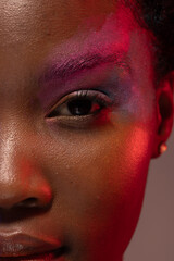 Half portrait of african american woman with short hair and colourful make up