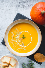 Roasted pumpkin and carrot soup with pumpkin  and hemp seeds. Pumpkin traditional soup with creamy silky texture.