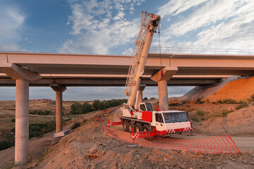 Crane trucks in the construction of a bridge