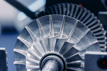 Macro steel blades of turbine propeller blue color with sunlight