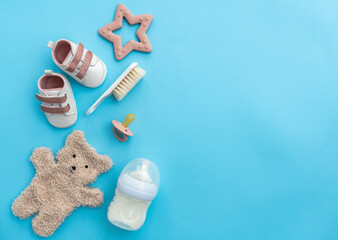 Infant essentials showcased on serene blue canvas, overhead shot