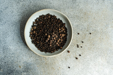 Bowl filled with natural aromatic Black pepper