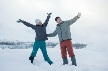 Positive couple taking selfie in winter