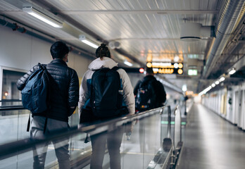Passengers standing on moving walkway at airport