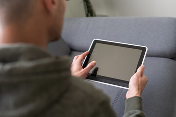 Digital tablet computer with isolated screen in male hands over cafe background