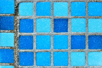 Blue tiled pool surface mosaic texture as background