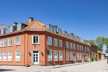 Fototapeta na wymiar Happy walking in old city of Fredrikstad, on a great warm summer day, with many old buildings, Norway