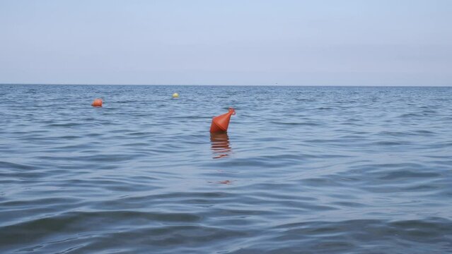 Orange buoy in the water.