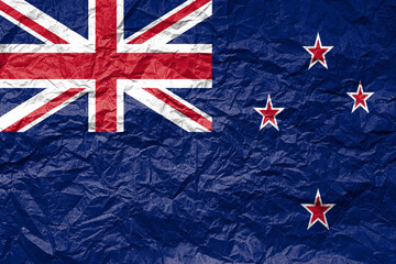 Flag of New Zealand on crumpled paper. Textured background.