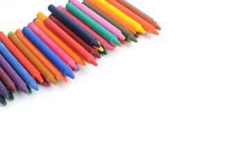 Crayons lined up isolated on white background.