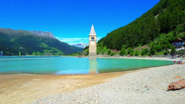 Lake Reschen - Vinschgau South Tyrol - fantastic flight aerial view of the church tower in the reservoir