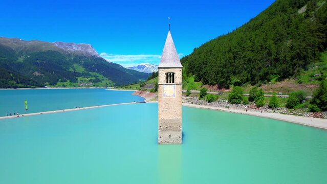 Lake Reschen - Vinschgau South Tyrol - fantastic flight aerial view of the church tower in the reservoir