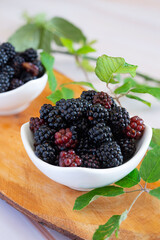 Wild berries in their natural state on a wooden cutting board