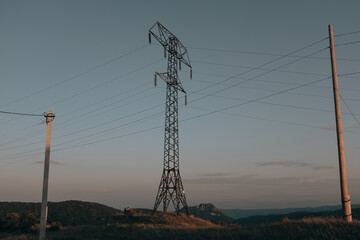 Old electricity tower, power lines in the morning