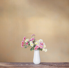 chrysanthemums in  vase on old wooden table