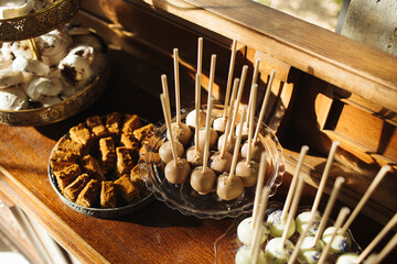 Wedding cake table background. Sweet and delicious restaurant desserts. Catering table. Bakery and pastry background. Cozy atmosphere wooden rustic vintage eating background.