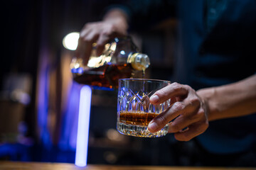 Bartender or businessman bartender pouring whiskey