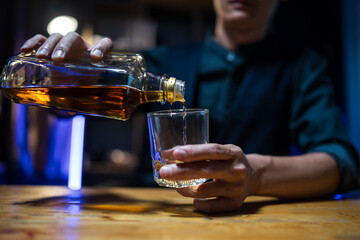 Bartender or businessman bartender pouring whiskey