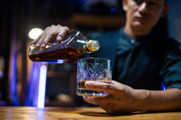 Bartender or businessman bartender pouring whiskey