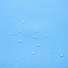 Water or rain drops on blue background 